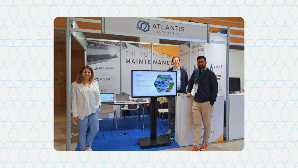 Team members from Atlantis Engineering and Holonix at a shared trade show booth during EuroMaintenance 2024, reflecting their ongoing collaboration in smart manufacturing and maintenance solutions.