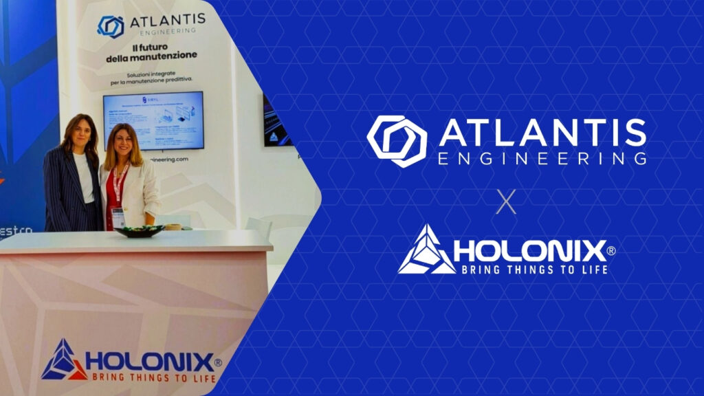 Two team members from Atlantis Engineering and Holonix at their co-branded booth during the BI-MU 2024 exhibition, presenting solutions in predictive maintenance, IoT, and digital asset management.