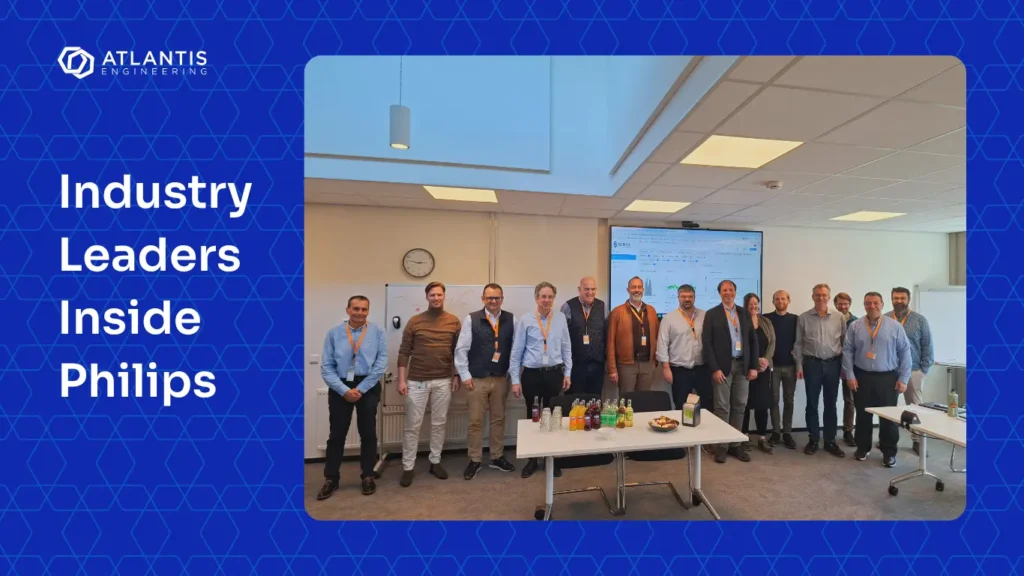 Photo of industry leaders inside Philips Drachten during their visit. Atlantis Engineering logo included.